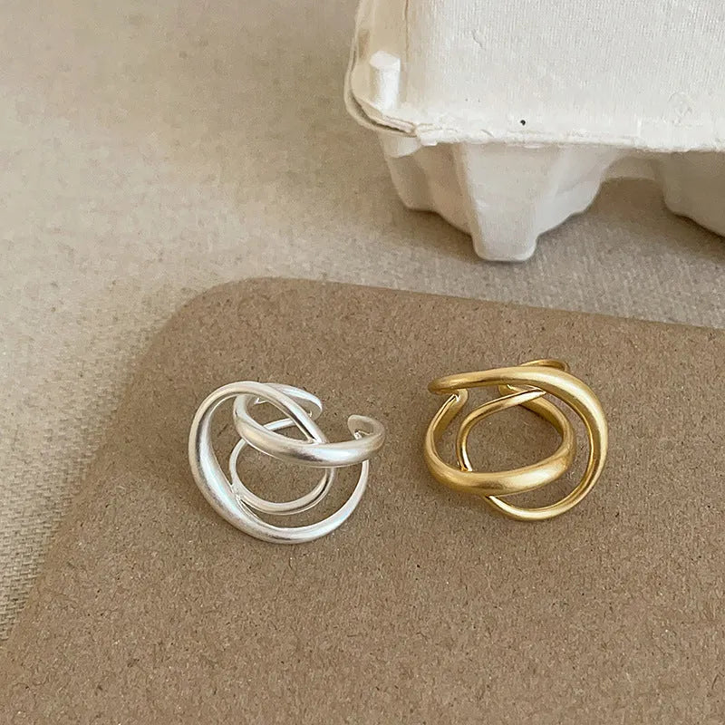 Geometric open ring for women with interlaced matte metal design and real gold plating