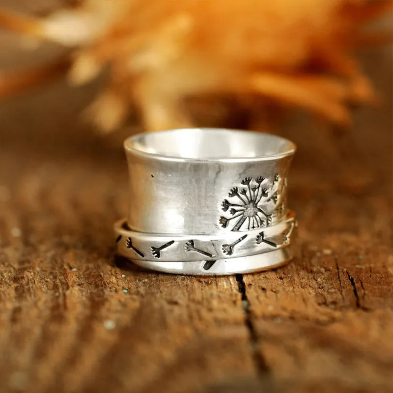 Silver rotatable flower fashion ring showing adjustable floral element and band