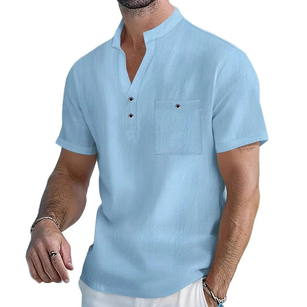 Man wearing a light blue linen-blend stand collar T-shirt with short sleeves and a loose fit.
