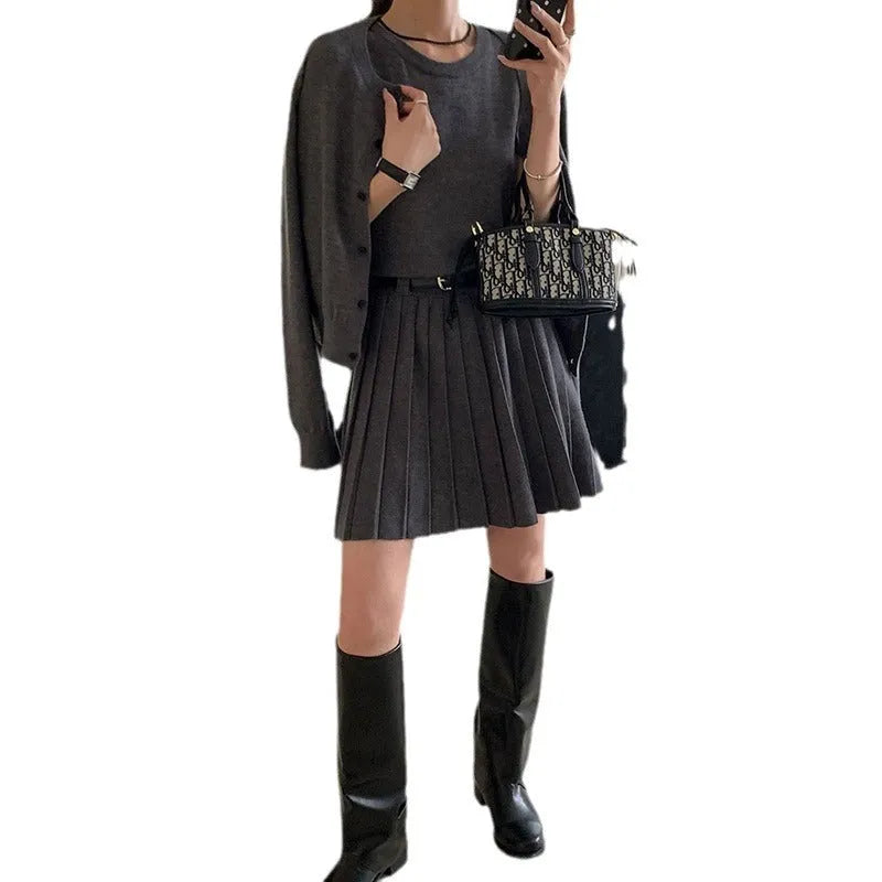 Women's grey knitted two-piece set with vest skirt, long-sleeved cardigan, belt, and 3D pattern detail
