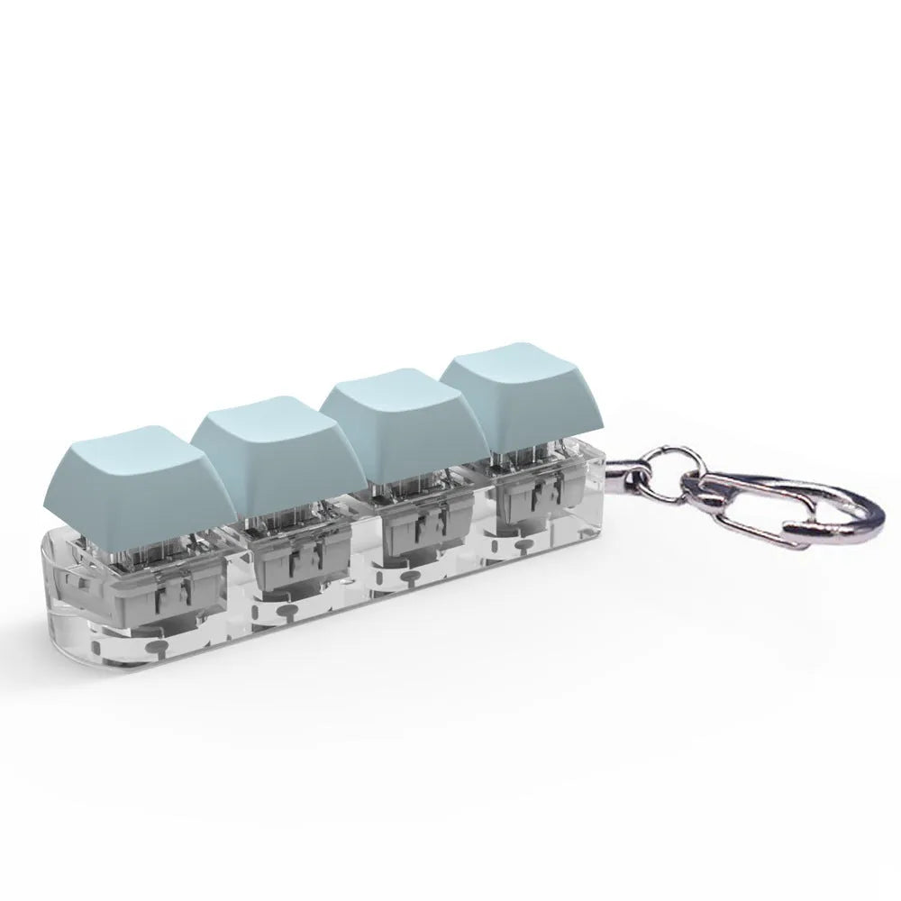 Four-key mechanical keyboard switch tester made of ABS plastic on a desk.