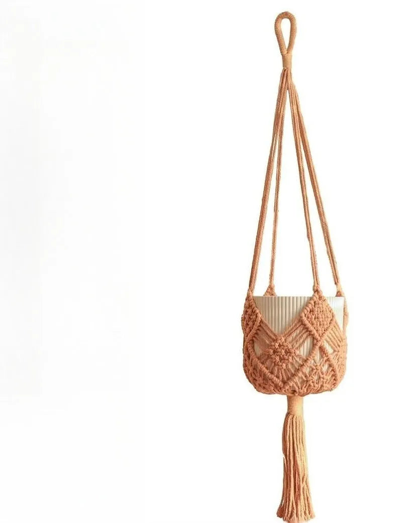 Handwoven brown polyester cotton flower pot net sleeve covering a plant pot.
