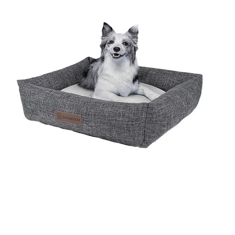 Grey plaid linen square dog bed for medium-sized dogs on a wooden floor.
