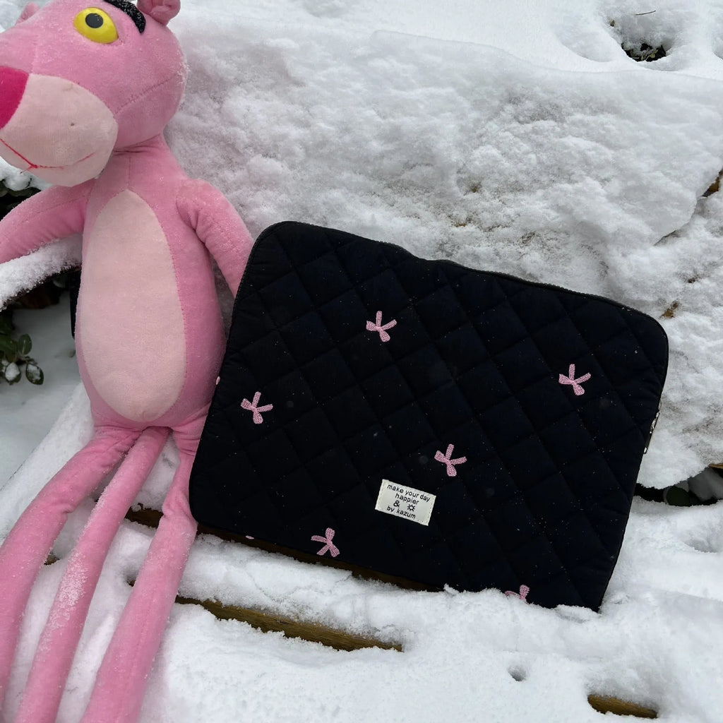 Nylon laptop storage bag with embroidered rhombus bow in light blue, showing size options.