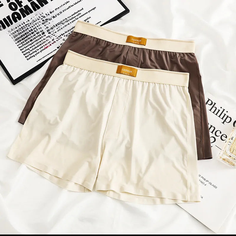 Pack of three pairs of men's solid colour ice silk underwear on a white background.