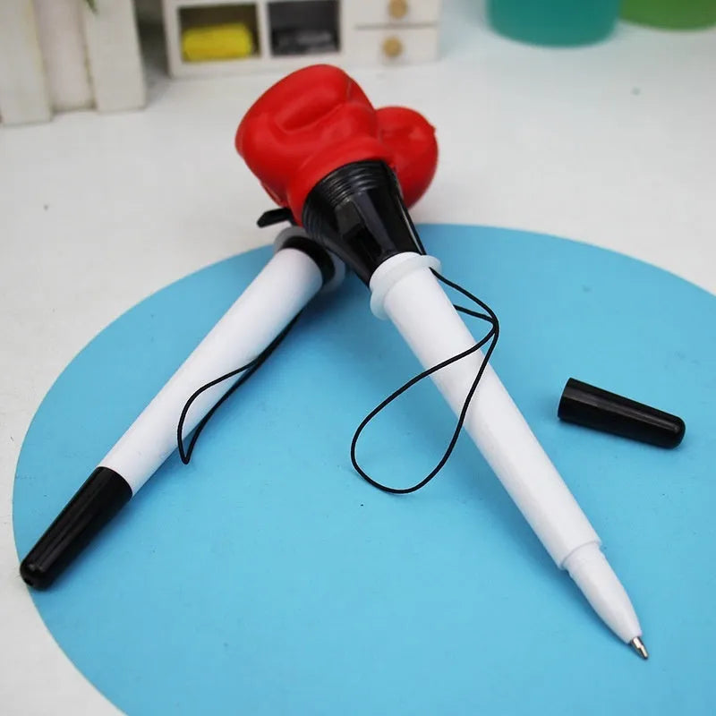 Set of four black ejection pens with a pressure relief boxing press button on the barrel.