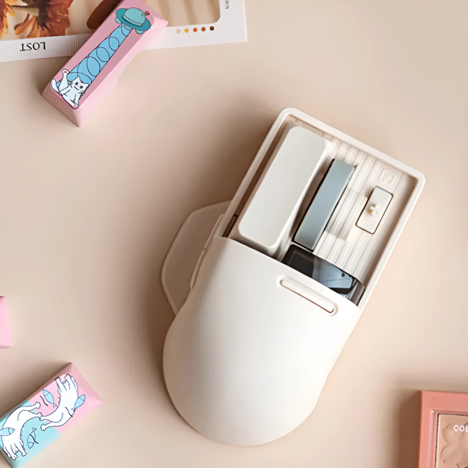Tofu coloured wireless computer mouse with three connection modes and seven-button configuration.
