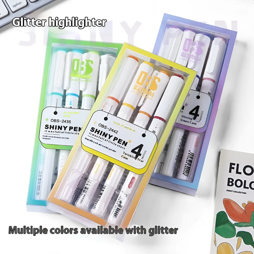Four glitter highlighter pens with pastel colours and slanted tips on a notebook.