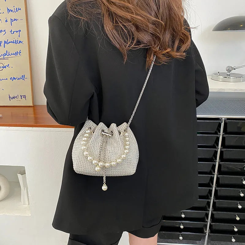 Diamond pattern crossbody bag with chain strap in bucket shape showing internal organisation compartments