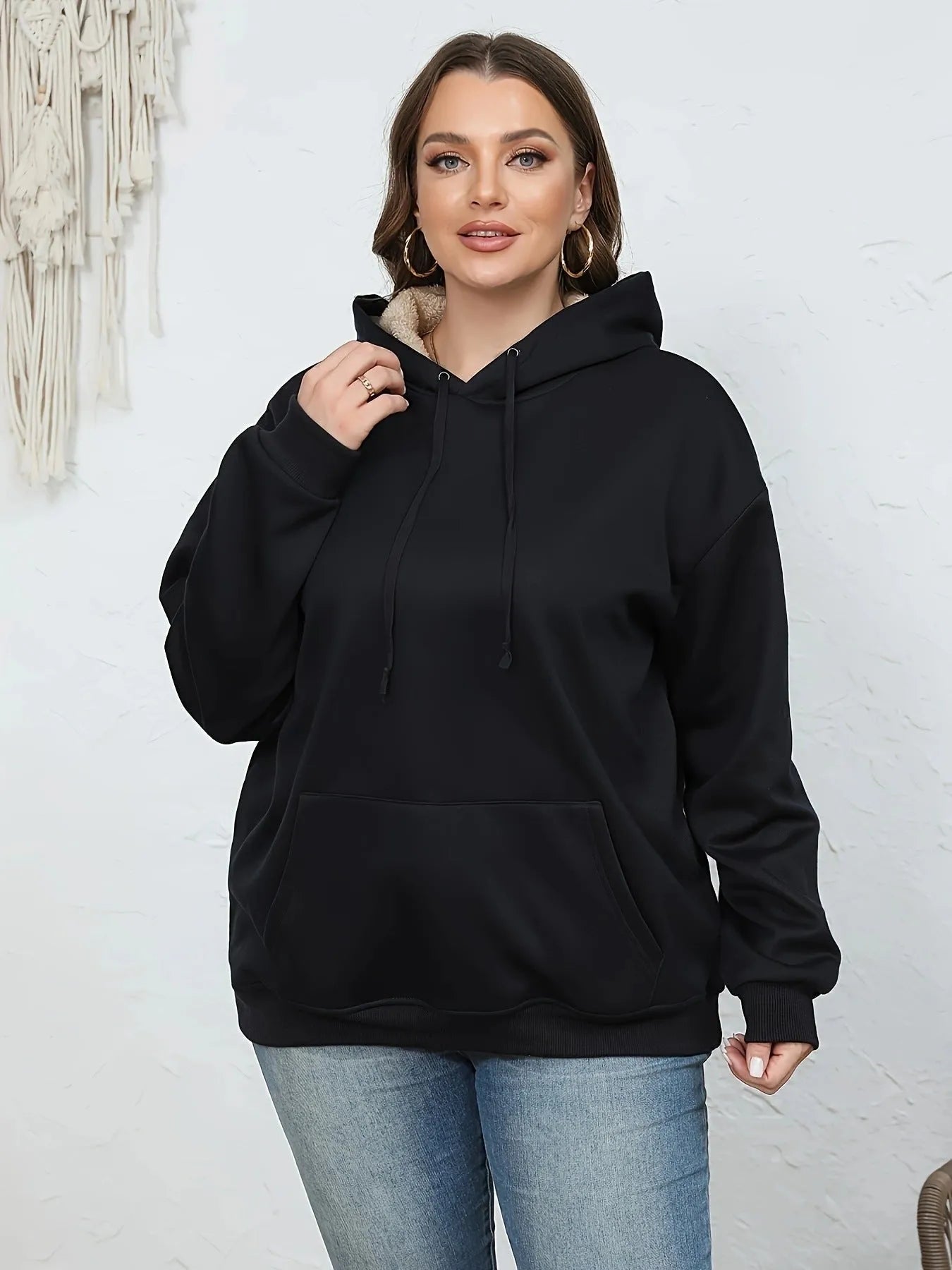 Women's loose grey hooded sweater with a 3D textured pattern on the front.
