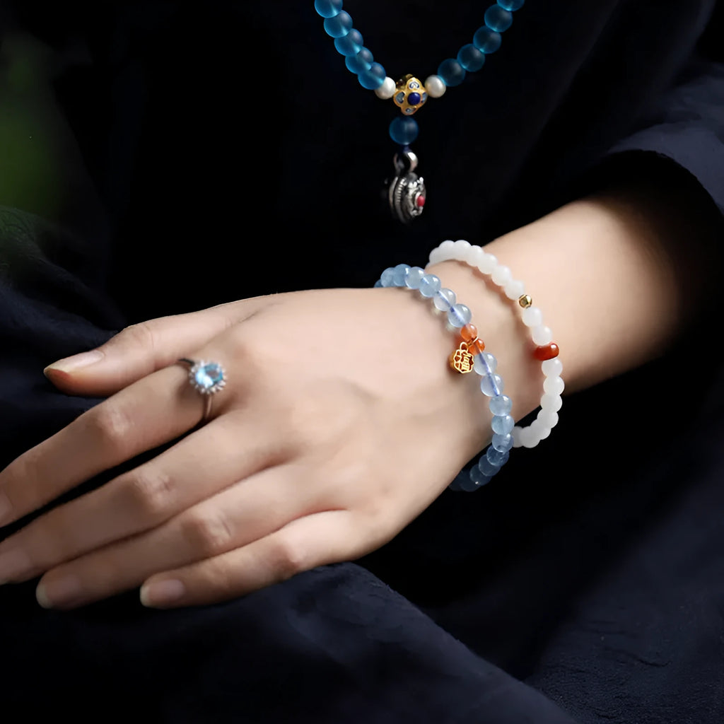Aquamarine natural crystal bead bracelet with sequin charms on elastic cord