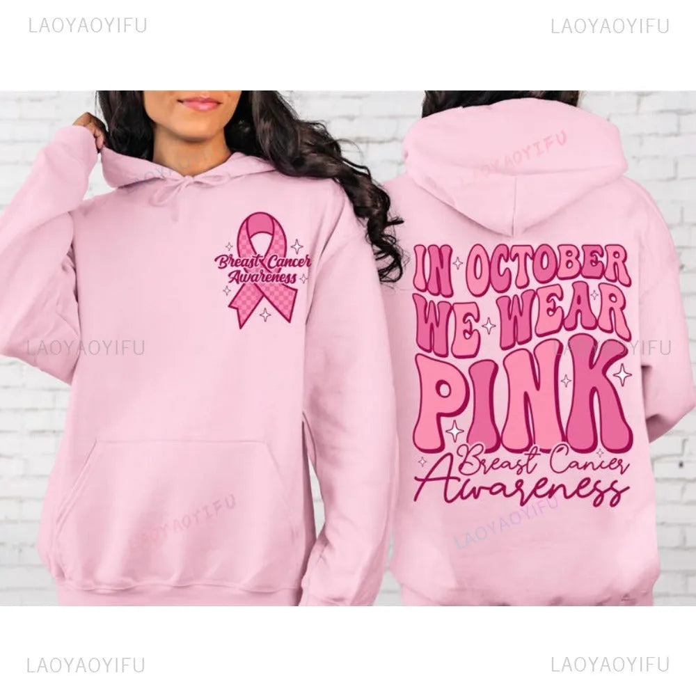 Women's pink breast cancer awareness pullover hoodie with retro graphic design and side seam pockets.