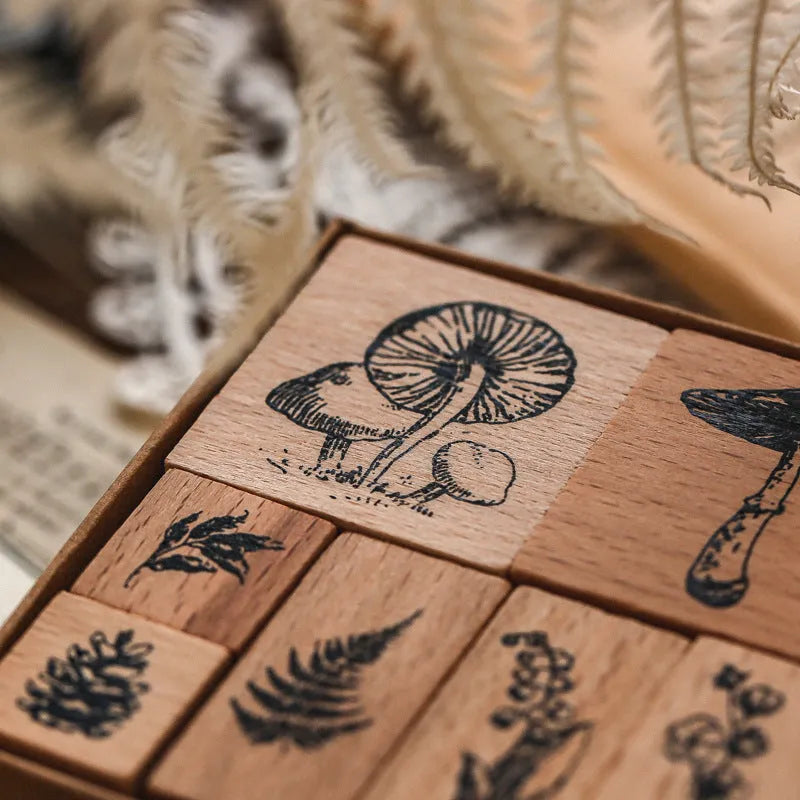 Wooden decorative seal stamp set with seven pieces showing botanical or celestial designs in mixed sizes
