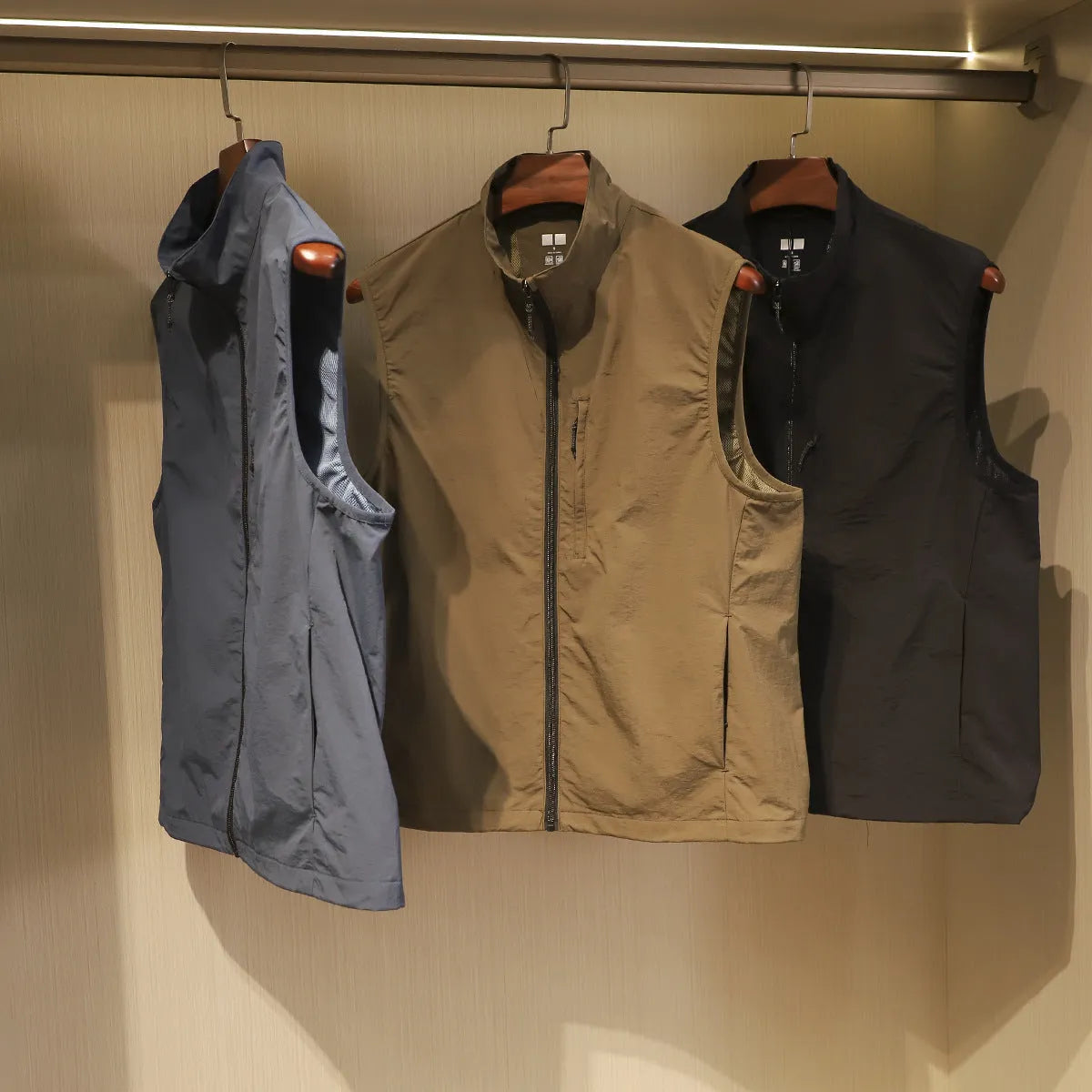 Men's straight-cut nylon cardigan vest in Army Green with side seam pockets.