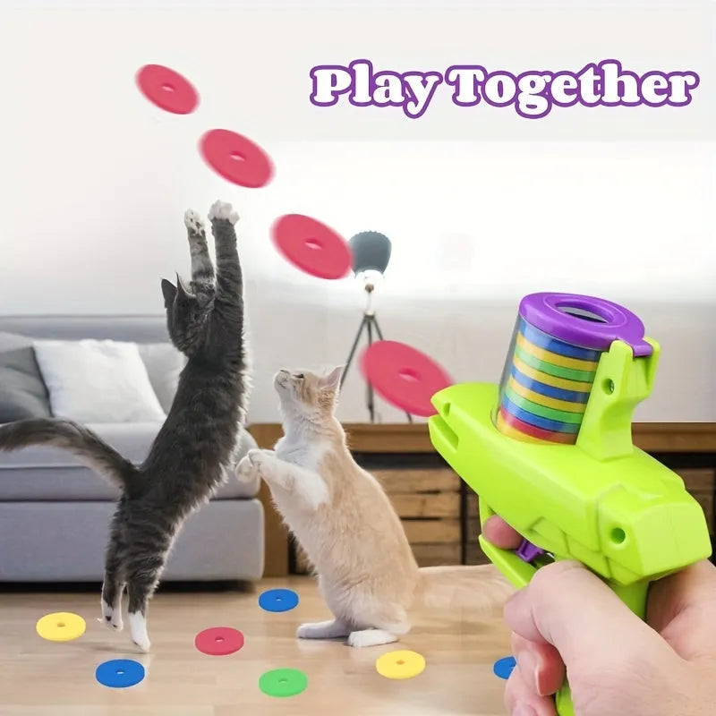 Green interactive cat toy launcher with three white foam discs on a carpet.