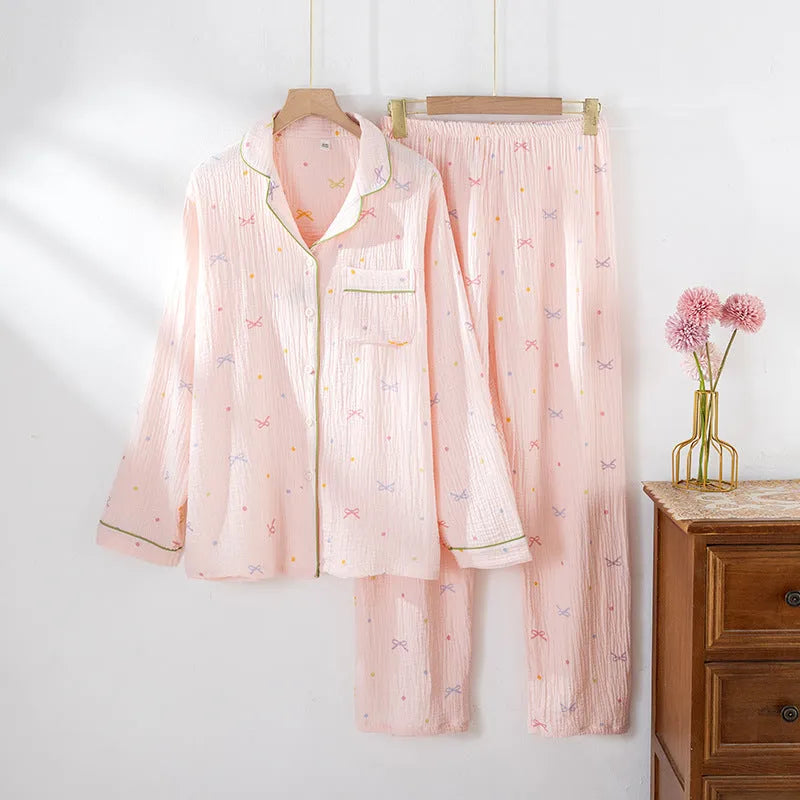 Women's beige long sleeve cotton pajama set with trousers, laid flat.