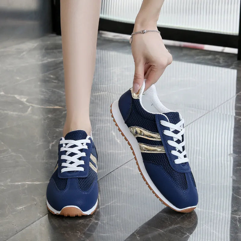 Blue women's tennis shoes with cross shoulder straps and lace-up front, artificial leather fabric uppers