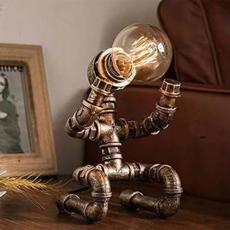 Industrial retro table lamp made from iron water pipes in vintage colour on a wooden desk