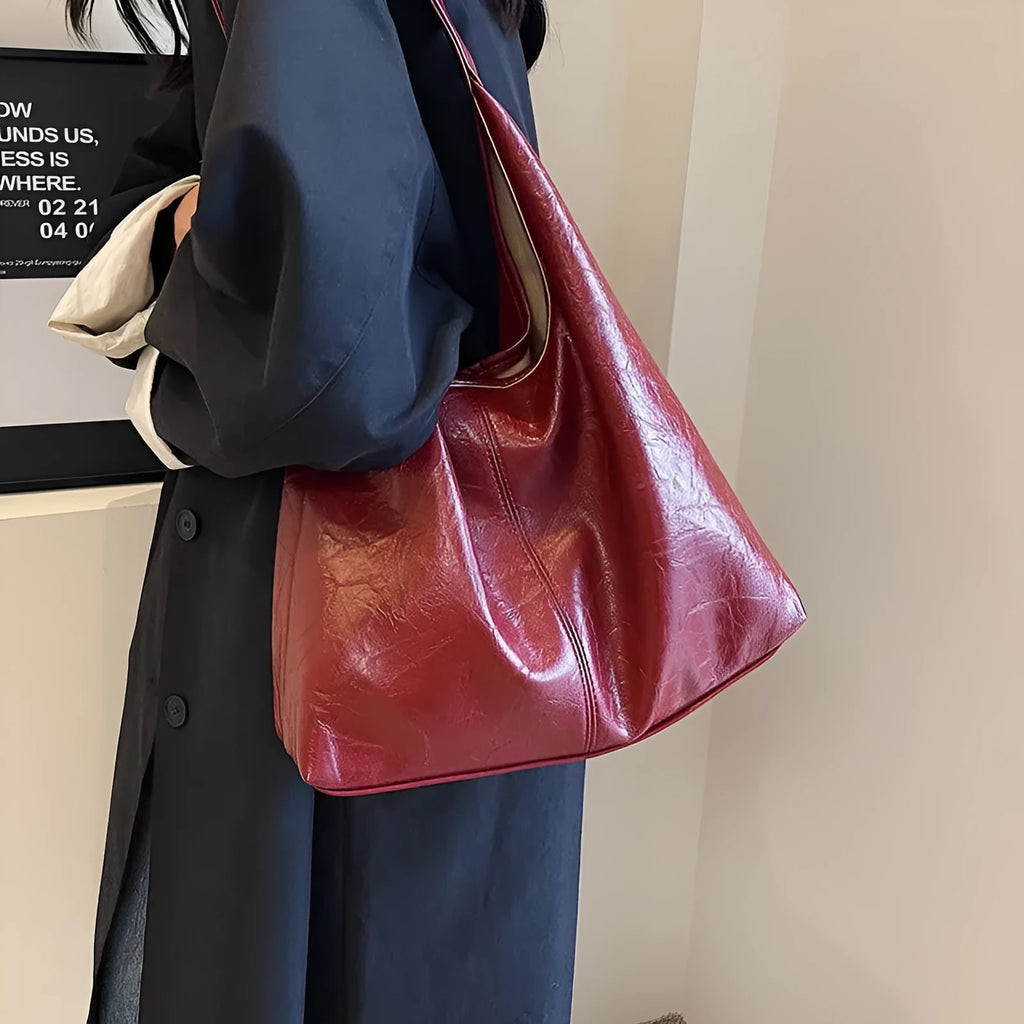 Soft leather shoulder bag in street style with sandwich pockets, shown in multiple colour options.