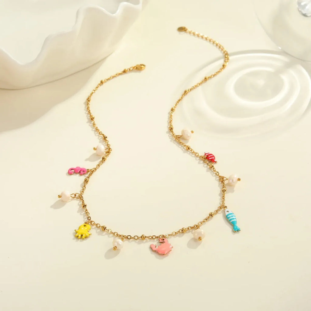 Stainless steel geometric pendant necklace with 18K gold electroplated chain and matching alloy bracelet on neutral background