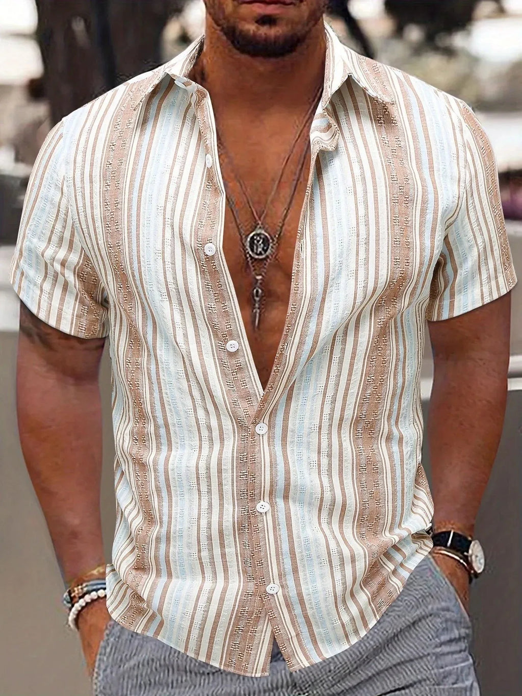 Man wearing a short sleeve striped casual shirt in a blue colour with a 3D printed pattern.