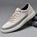Men's grey low-top pigskin leather skate shoes with flat rubber sole and lace-up front.