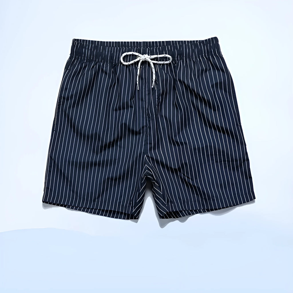 Navy blue and grey striped beach shorts with a straight leg opening on a mannequin.