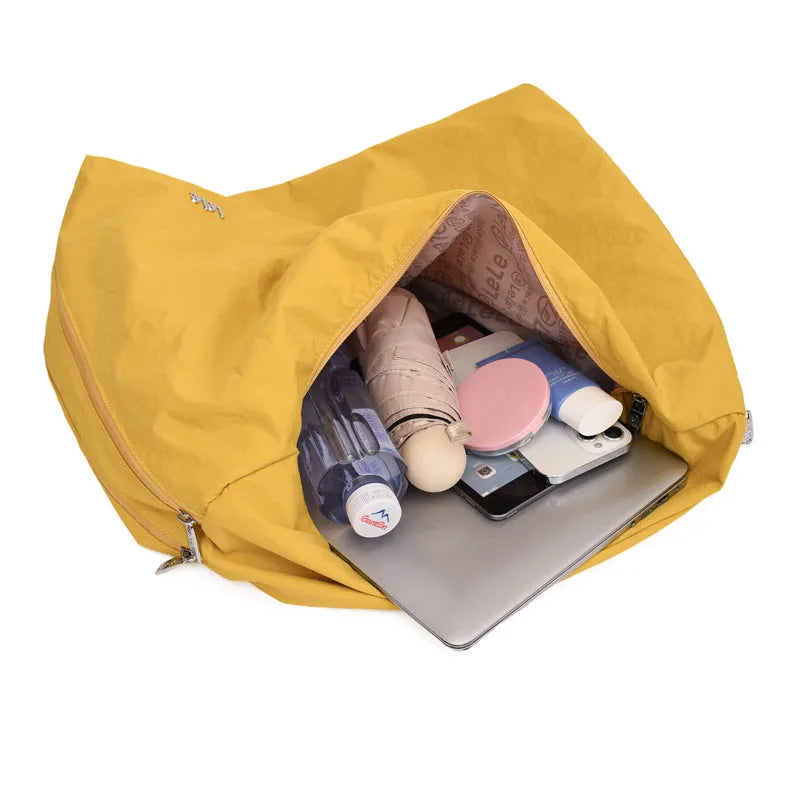 Soft nylon women's underarm bag in a heart shape, shown in black, blue, khaki, and yellow colour options.