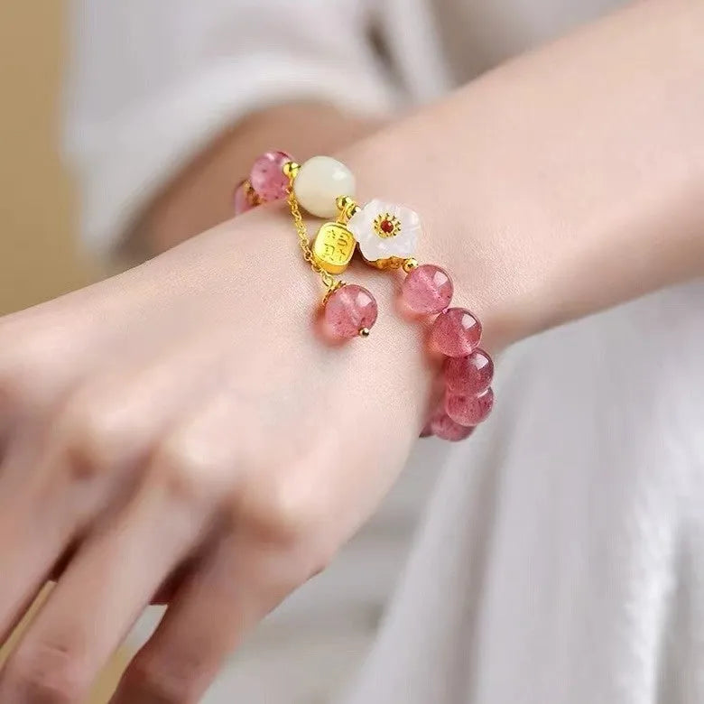 Handcrafted strawberry quartz crystal bracelet with green moon beads and peach blossom Hetian jade charm on adjustable string