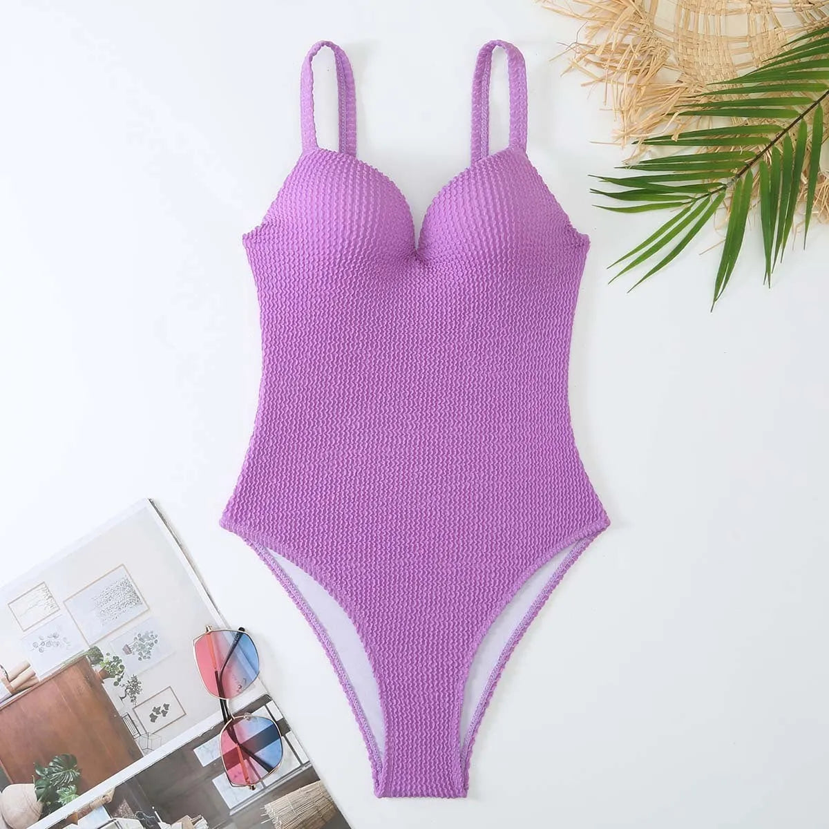 Women's one-piece swimsuit with sunken stripe pattern in polyester fabric, shown in multiple colour options