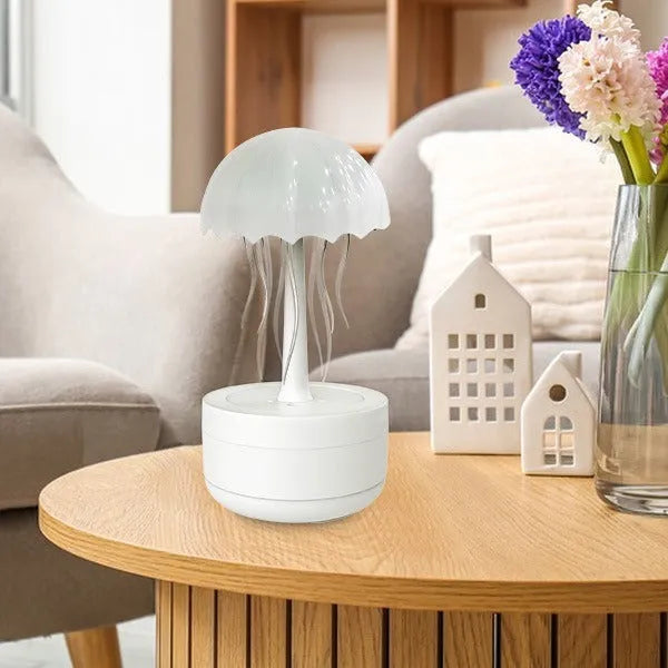 White jellyfish-shaped humidifier and essential oil diffuser with colourful LED lights on a desktop
