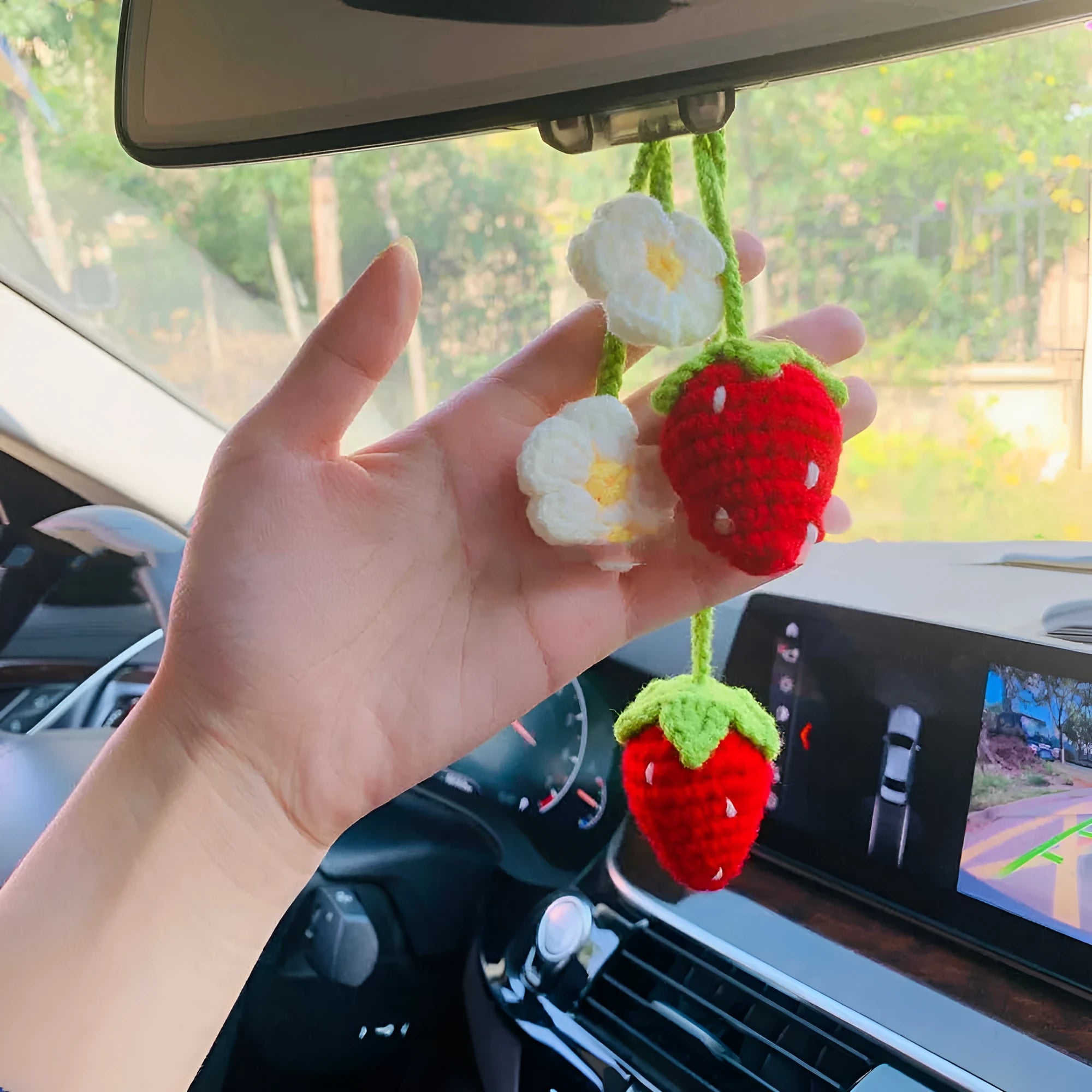 Handmade woven strawberry-shaped car hanging ornament made from cotton and hemp yarn with a Lily of the Valley hook.