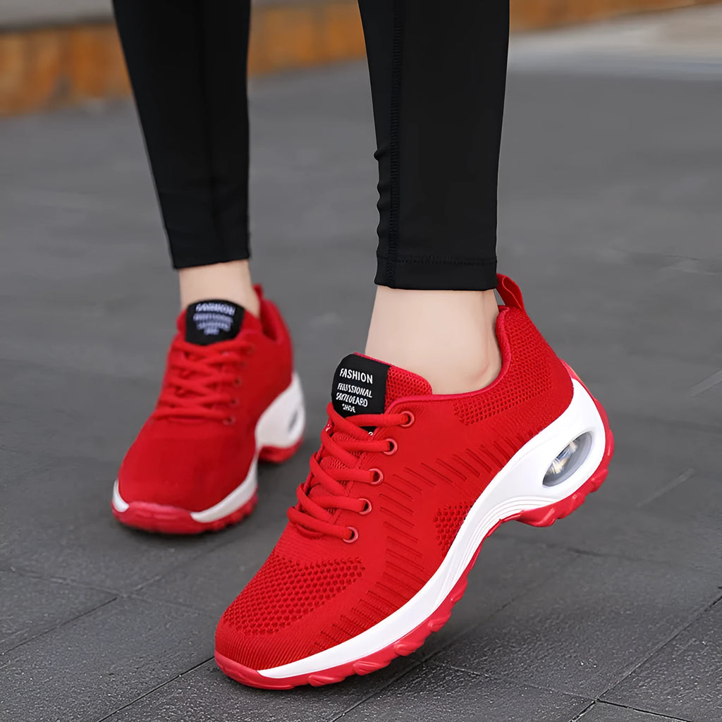 Women's red and black mesh sneakers with lace-up front and round toe design