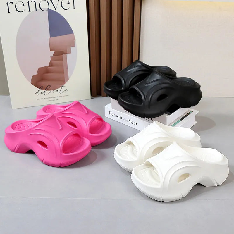Women's white EVA slippers with thick sole and round toe on a beach background