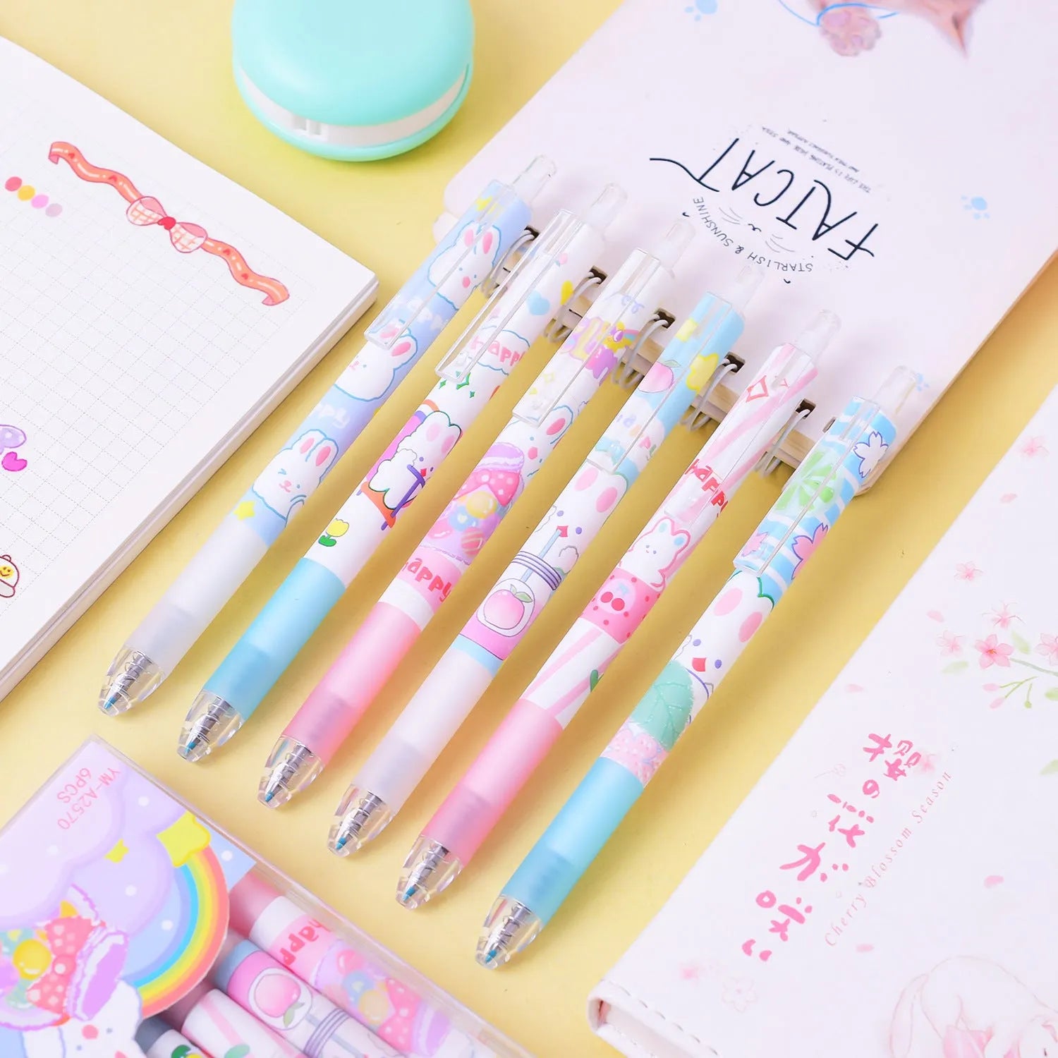 Six black plastic pens with cartoon bunny design and 0.5mm fine tips in an open box.