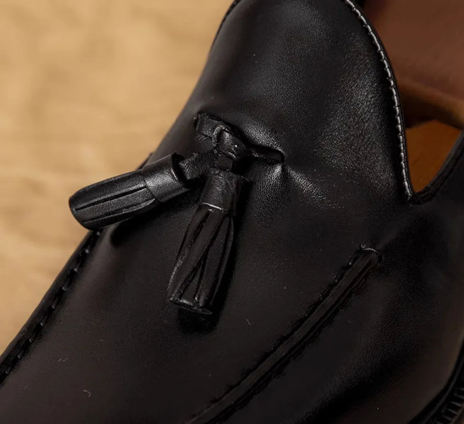 Men's black and brown genuine leather slip-on loafers with a pigskin lining, shown in multiple sizes.