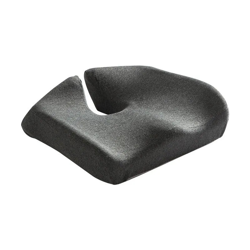 Dark grey memory foam office chair cushion for waist support, shown on a desk chair.