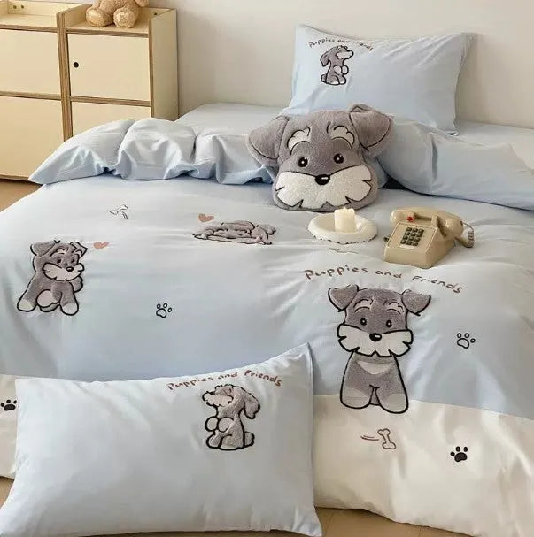 Schnauzer dog cartoon embroidered cotton bedding set with quilt cover, sheet, and pillowcases on a bed.
