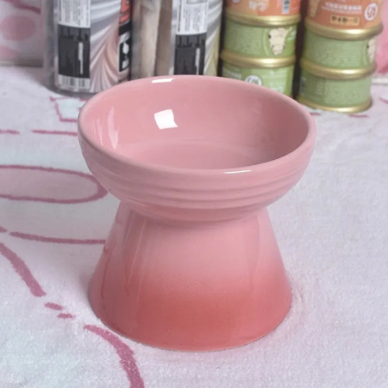 A white ceramic pet bowl with a high foot and raised neck protector to prevent tipping.
