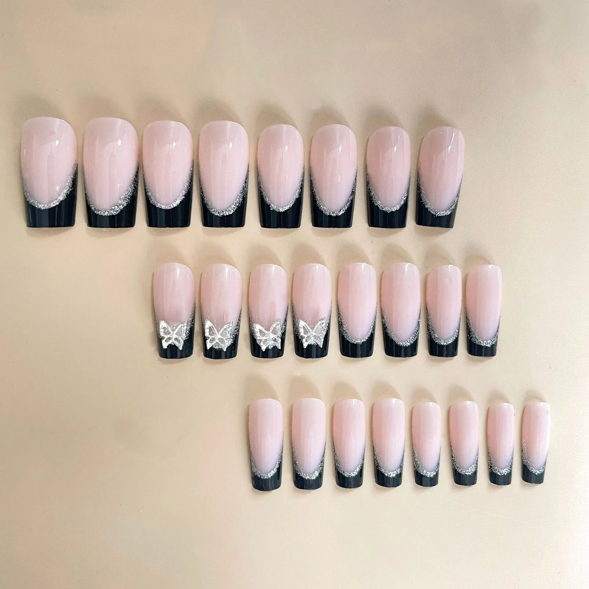 French-style false nails with glitter butterfly pattern and flash details on medium-length thin nails