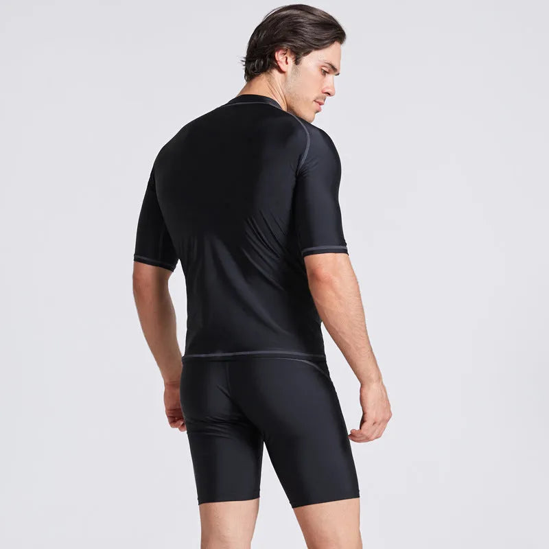 Men's navy blue quick-drying nylon swimsuit set with half-sleeve top and pants for swimming and surfing.
