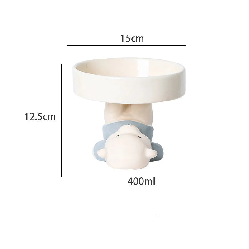 White ceramic raised cat bowl with bear design, showing wide opening and elevated base.