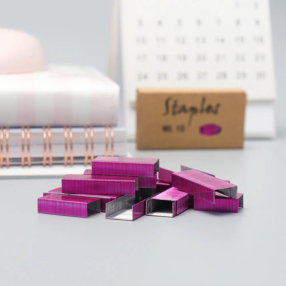 A box of 1000 metal office staples in choices of black, purple, rose gold, or rose red colour.