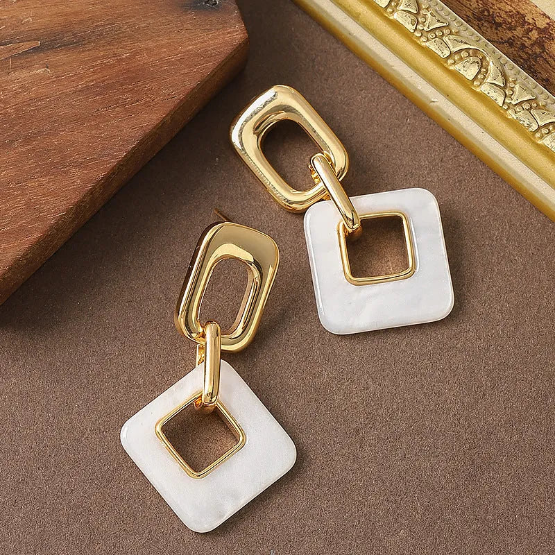 Hollow geometric square earrings with chamfered corners in metallic finish