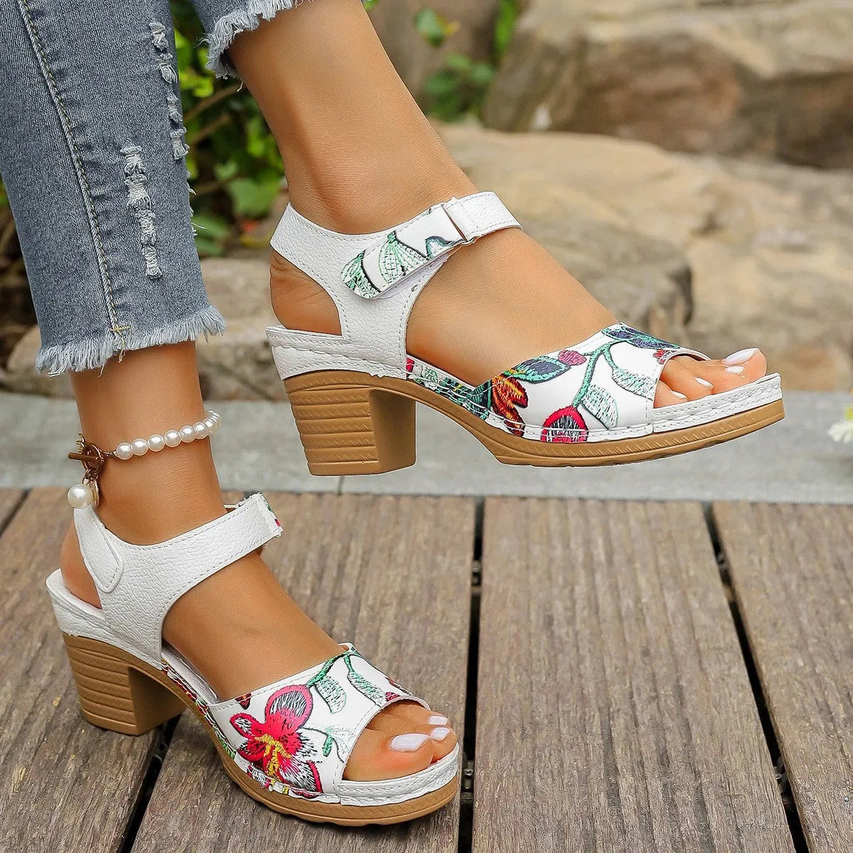White women's high heel sandals with an adjustable velcro buckle strap on a rubber sole.
