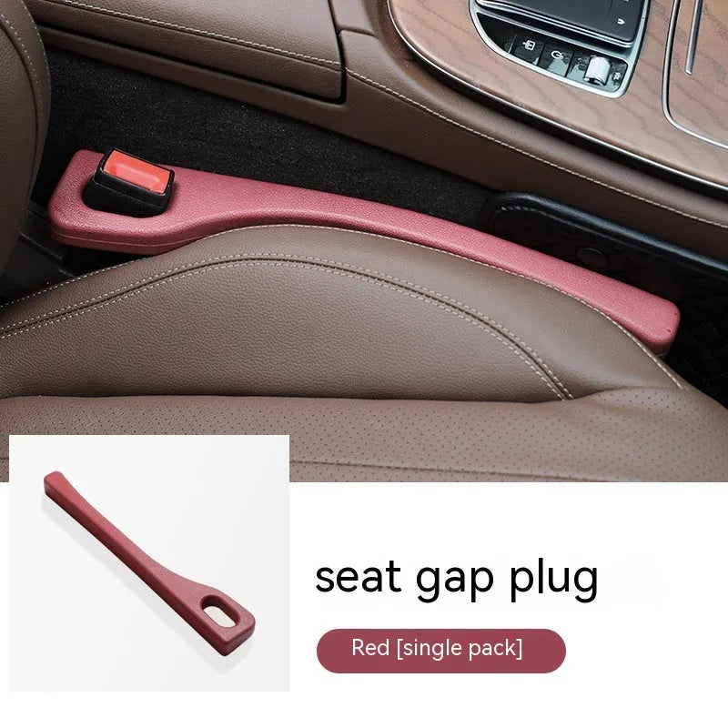 Flexible polyurethane car seat gap filler strip in beige colour on a car seat.