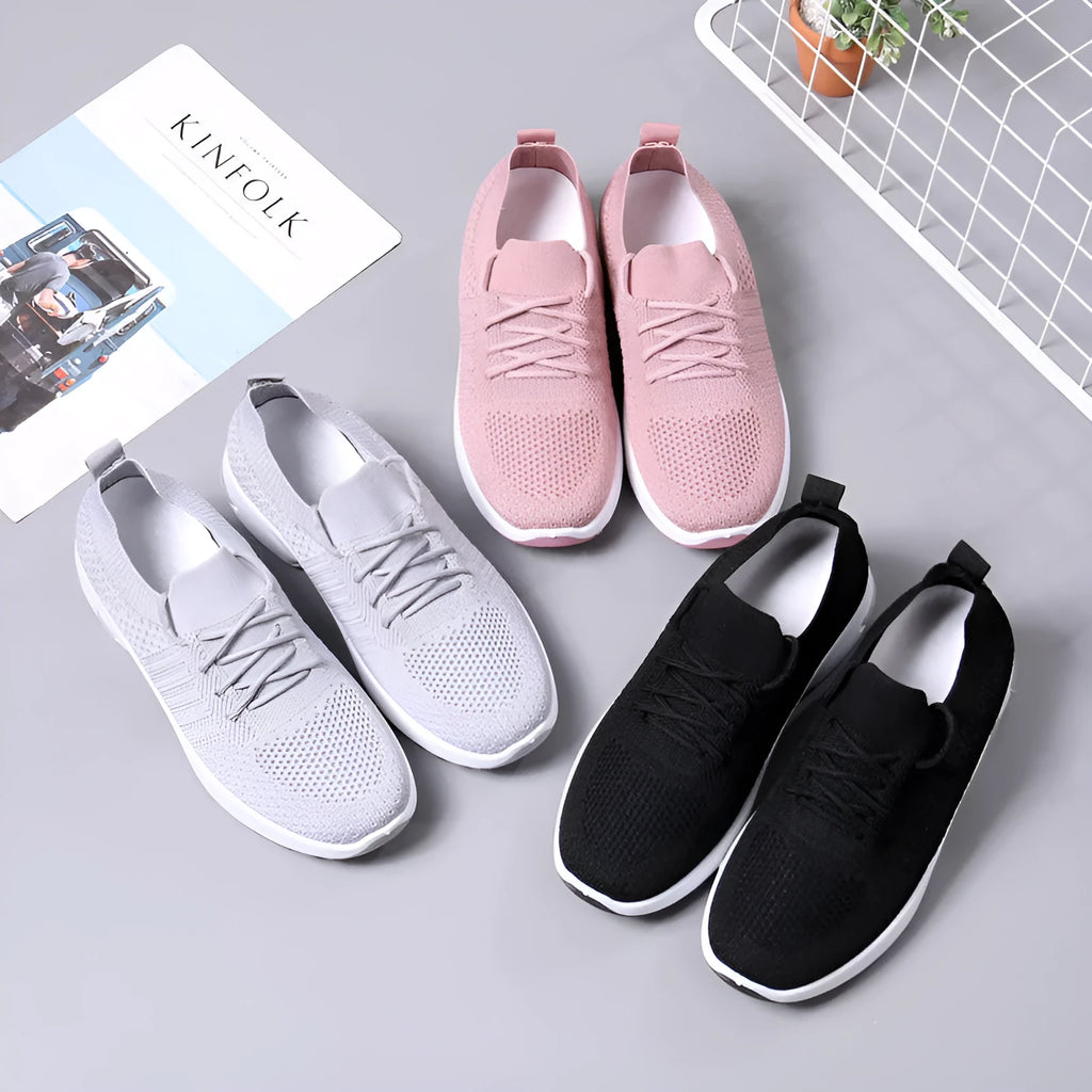 Women's black casual sneakers with mesh upper and non-slip PVC soles, shown with lace-up front closure