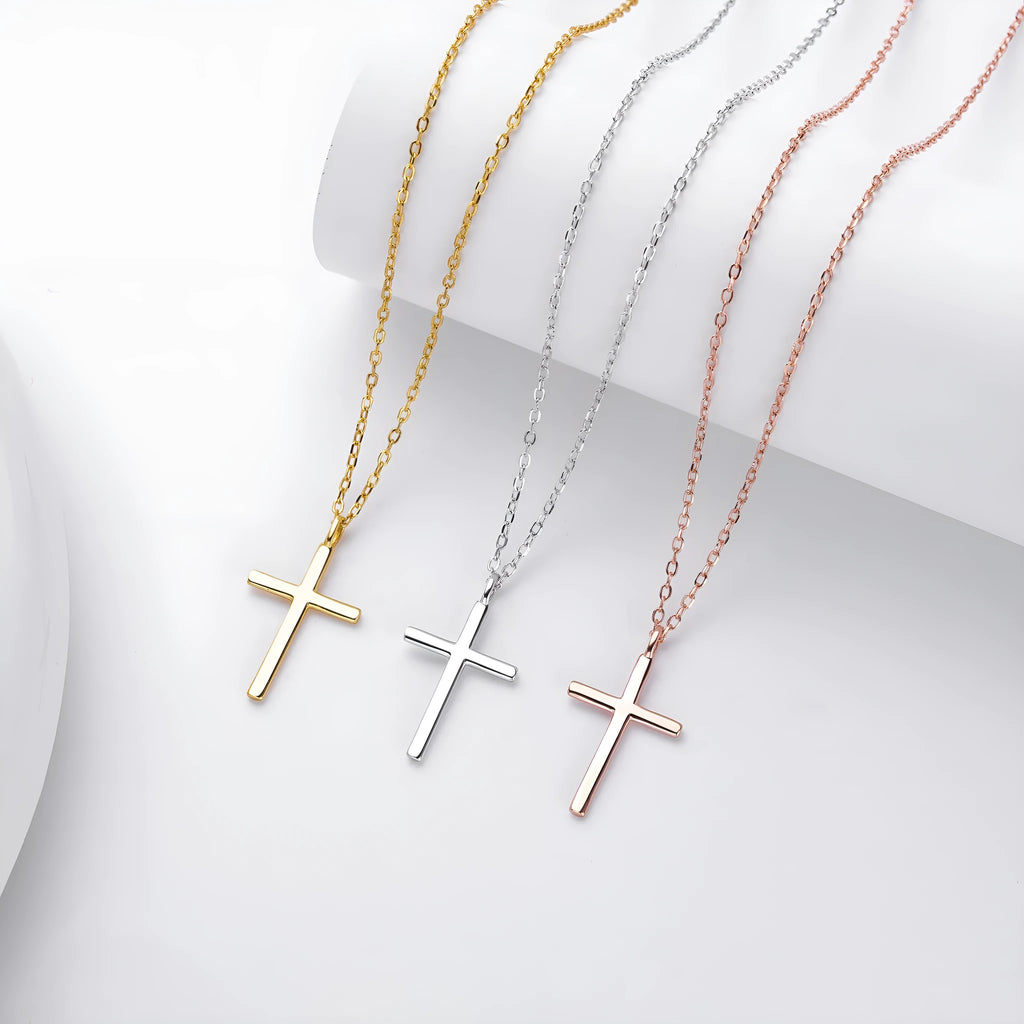 Sterling silver cross necklace with O-shaped chain in gold plating on display