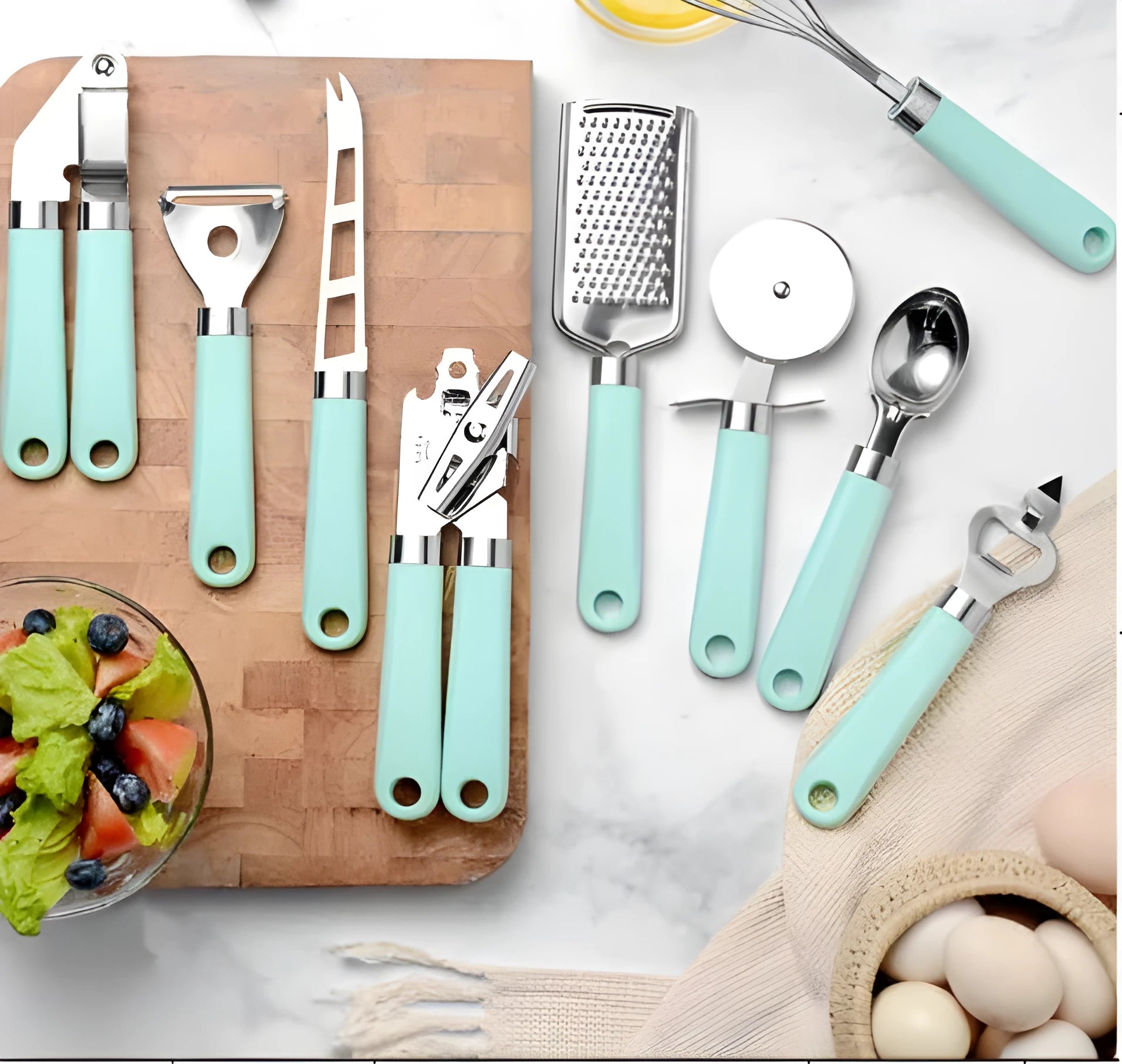 Set of nine stainless steel kitchen utensils with plastic handles in green, black, black and red, and black and green colour options on a light background