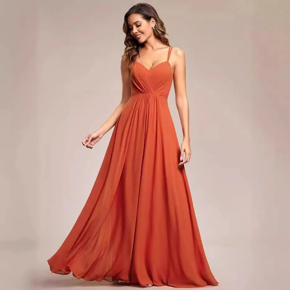 Women's light green sleeveless dress with sling neckline and long pleated A-line skirt.